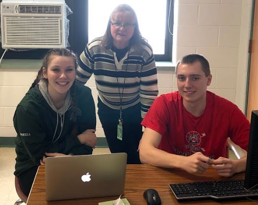 Mrs. Allen (center) works with seniors Madison Gaskell (left) and Sean Menard. 