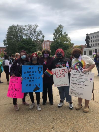 The author airs her voice with friends at the demonstration in Concord (from left to right): Brooke Robinson, Anevay Stauffacher, former Senator Melanie Levesque, Finn Bell and Eli Boucher.