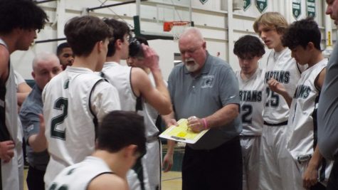 Coach Donnell gathers his players during a timeout. 